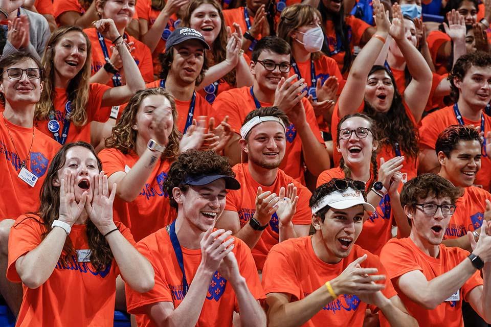 Oriflamme members sitting and cheering in arena stands