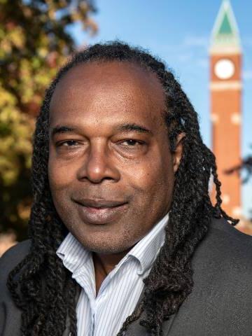 Jonathan Smith Headshot with clock tower in the background.